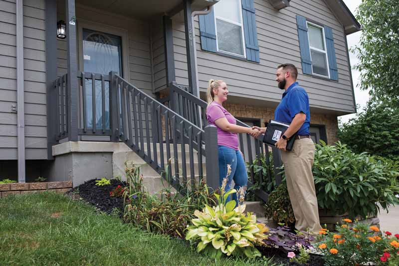 dealer greeting customer on porch